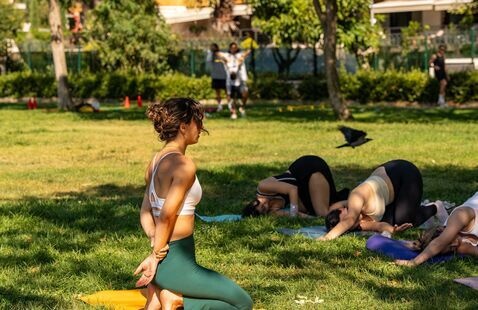 A person leading an outdoor yoga session.