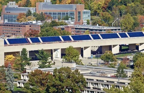 Aerial shot of UMass campus featuring solar panels on the fine arts center