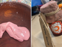 handmade pink slime in a wooden bowl and a glass jar of homemade red watercolor liquid capped with cloth and labeled "Blood Moon"