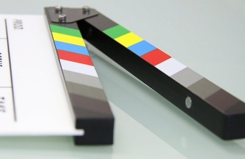 A clapperboard with colorful stripes