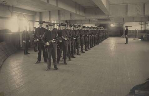 Cadet drill early 1900s in the basement of Budge Hall