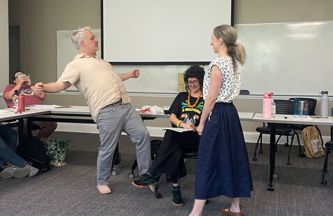 People dancing awkwardly in a classroom