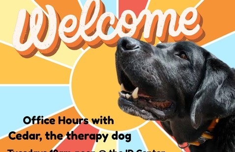 Photo of black lab with the word welcome above