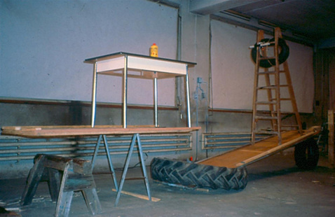 Tables and tires that are a part of the Rube Goldberg contraption filmed in "The Way Things Go."
