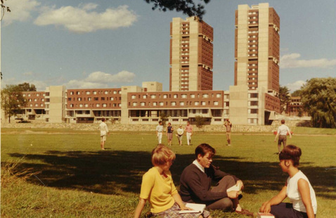 Students sitting on grass west of the Southwest Residential Area, undated. University Photograph Collection.