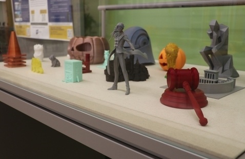 3d printed figures in an exhibit case.