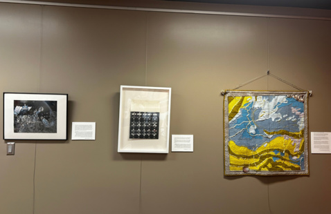 Three pieces of art hanging on a wall