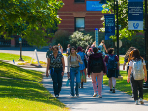 Groups of students bustle about campus on the first day of classes.