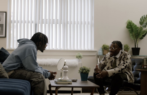 Bobby Cius sits on a couch talking to a counselor version of himself. 