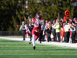 Colgate Football player running to catch the football