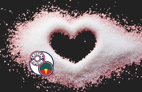 Sugar forms heart on black background with American Crystal Sugar logo