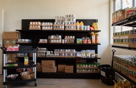OSU Food Pantry shelves stocked with canned beans, juice and other dry goods.