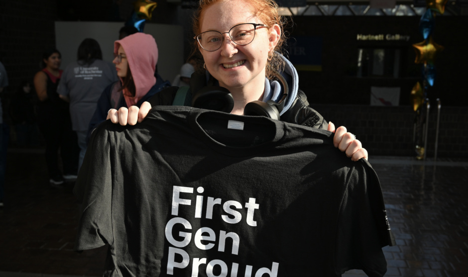 Student holding a first-gen proud t-shirt. 