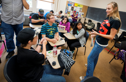 Picture of students and OSU outreach assistant in a classroom setting.
