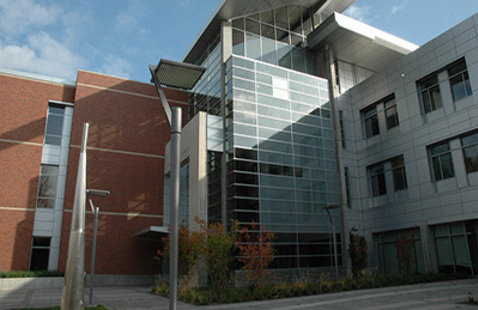 Exterior of a red-brick and glass building on Corvallis campus.