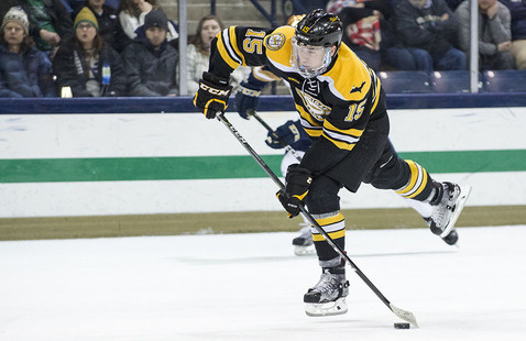 Hockey player shooting the puck.