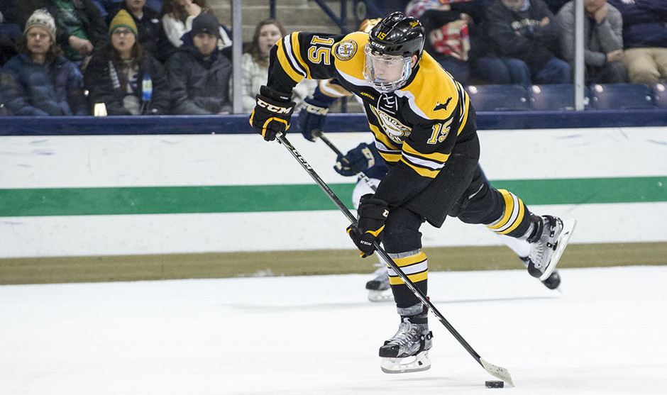 Hockey player shooting the puck.