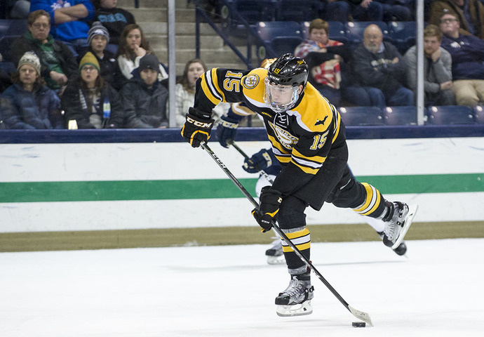 Hockey player shooting the puck.
