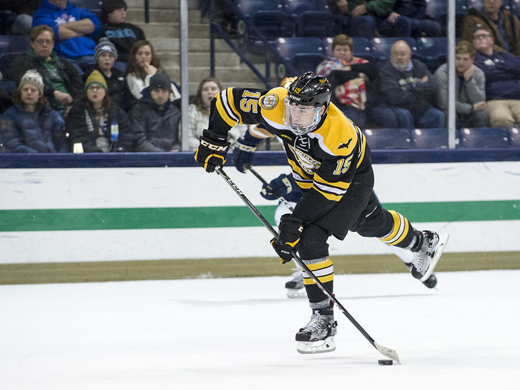 Hockey player shooting the puck.