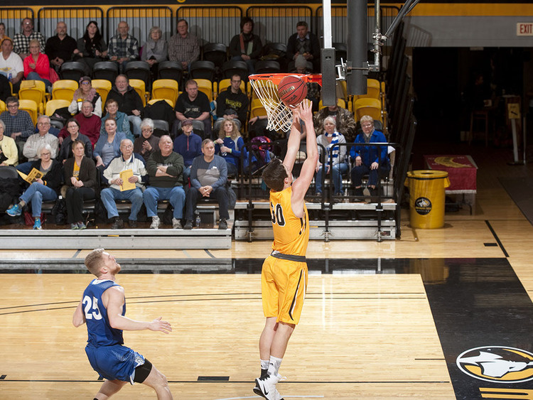 Basketball player going up for a rebound.