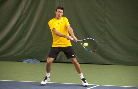 Tennis player hitting a ball.