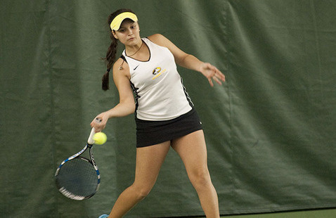 Tennis player hitting a ball.